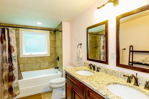 a bathroom with two sinks and a tub and a toilet at Sweet Refrain in Pisgah Forest