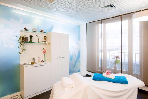 a room with a bed and a window at NH Collection Berlin Mitte am Checkpoint Charlie in Berlin