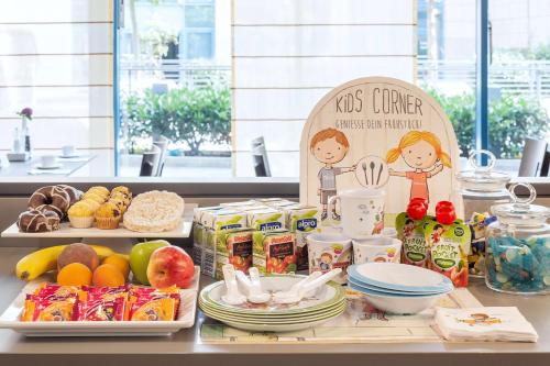 a table with a buffet of food on it at NH Collection Berlin Mitte am Checkpoint Charlie in Berlin