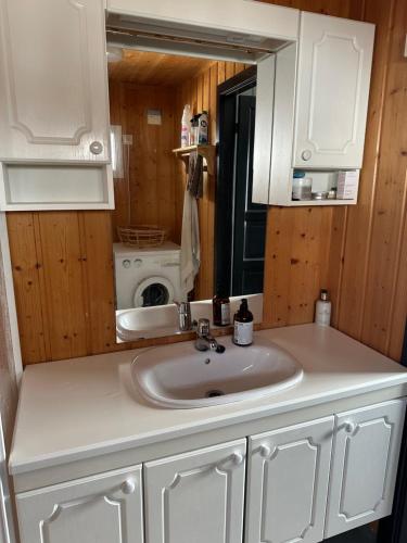 a bathroom with a sink and a mirror at Chalet Skogshorn in Markegardlian