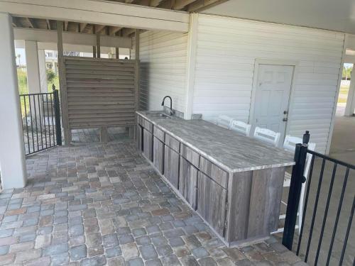 a patio with a sink on the side of a house at Sea Watch-Beachfront-Private Pool-Pet Friendly in St. George Island