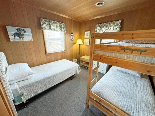 a bedroom with two bunk beds and a lamp at KH4300- Weather Station in Kitty Hawk