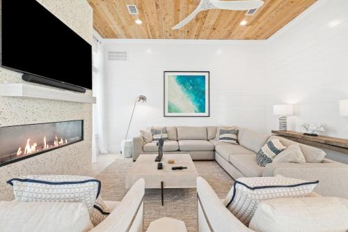 a living room with a couch and a fireplace at Bullish On Beaches in Inlet Beach