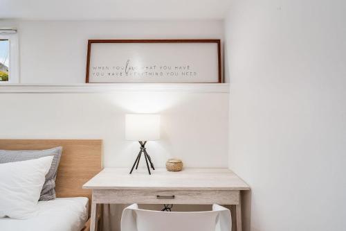 a bedroom with a bed and a desk with a lamp at Perch - Queen Ann Vintage Charm in Seattle