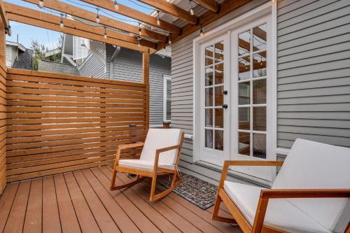 a patio with two chairs and a table on a deck at Perch - Queen Ann Vintage Charm in Seattle