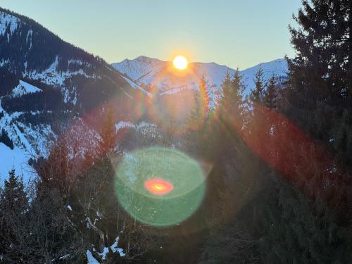 a frisbee in front of a mountain with the sunset at Appartementhaus Casamarai in Saalbach Hinterglemm