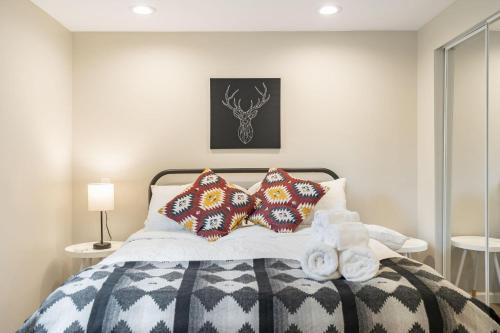 a bedroom with a bed with two pillows on it at Perch - Shoreline Gathering Spot in Shoreline