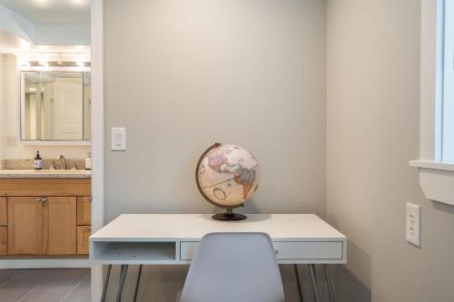 a white desk with a globe on it in a bathroom at Perch - Shoreline Gathering Spot in Shoreline