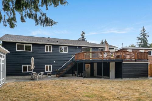 a large house with a deck and a house at Perch - Gathering Spot Lower in Shoreline