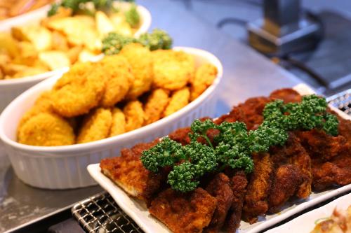 a plate of food withfried foods and a bowl of fries at Dormy Inn Premium Fukui Natural Hot Spring in Fukui