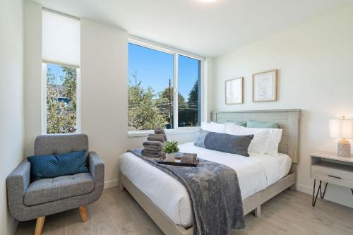 a bedroom with a bed and a chair and a window at Perch - Urban Reflection 13 in Seattle
