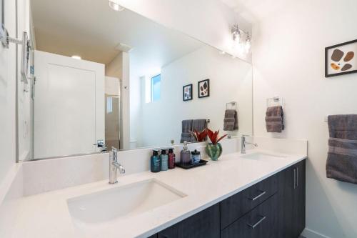a bathroom with two sinks and a large mirror at Perch - Urban Reflection 13 in Seattle
