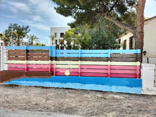 a colorful fence in front of a house at CASA MARINERA ALCOSSEBRE in Alcossebre