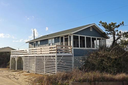 a blue house sitting on the side of a beach at SN8421- Sandpiper in Nags Head