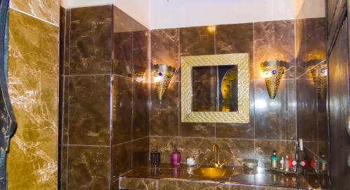 a bathroom with a sink and a mirror at Riad Terra Bahia in Marrakech