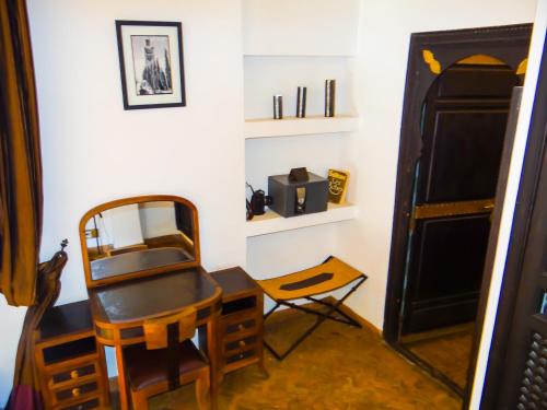 a room with a desk and a chair and a table at Riad Terra Bahia in Marrakech