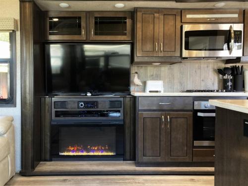 a kitchen with an oven with a fire in it at Driftwood in Fort Bragg