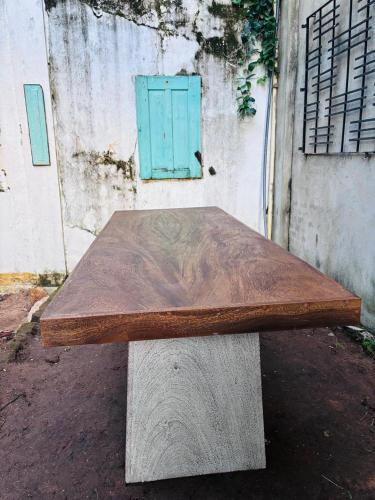 a wooden table sitting on top of a bench at The Fort Library Hostel in Galle