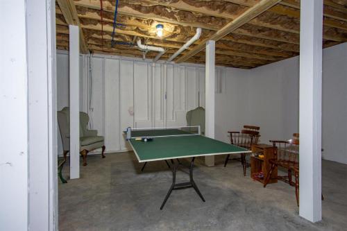 an empty room with a ping pong table in it at BKs Hideaway in Pisgah Forest