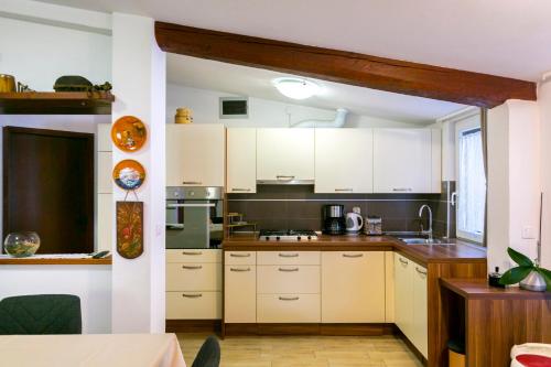 a kitchen with white cabinets and a counter top at Elvira - Apartment Bungalow - MPolo in Medulin