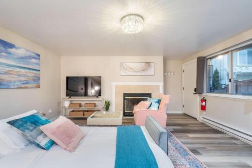 a bedroom with a large bed and a fireplace at Perch - Queen Ann Flat in Seattle