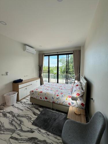 a bedroom with a bed and a window at Dragon Pool Villa Aonang in Ao Nam Mao