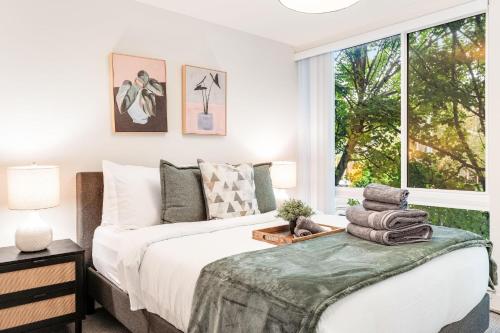 a bedroom with a bed and a window at Perch - View on Franklin in Seattle