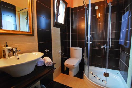 a bathroom with a sink and a toilet and a shower at INSPIRA THASSOS APARTMENTS and STUDIOS in Skala Sotiros