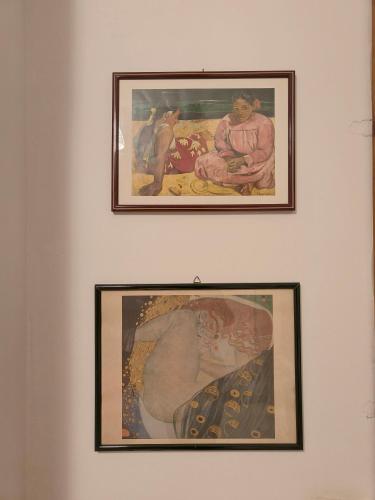 two framed paintings on a white wall at B&B IL POETA in Palermo