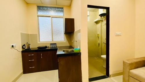 a bathroom with a sink and a toilet and a window at Stay10 B&M LUXURY ACCOMDATION in Indore