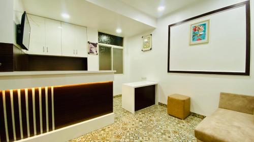 a living room with a counter and a couch in a room at Stay10 B&M LUXURY ACCOMDATION in Indore