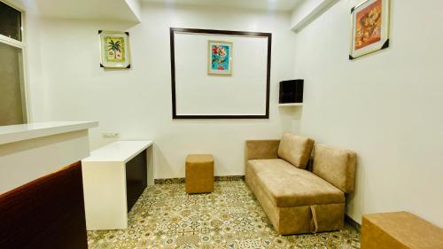 a living room with a chair and a table at Stay10 B&M LUXURY ACCOMDATION in Indore