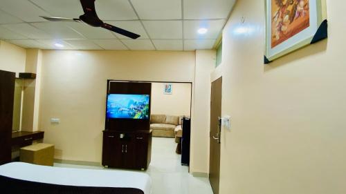 a hospital room with a tv and a couch at Stay10 B&M LUXURY ACCOMDATION in Indore