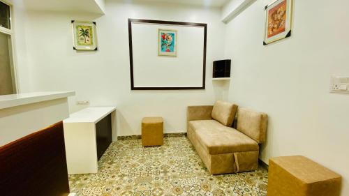 a living room with a chair and a table at Stay10 B&M LUXURY ACCOMDATION in Indore