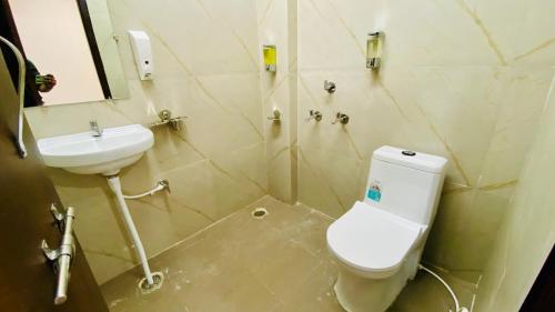 a bathroom with a toilet and a sink at Stay10 B&M LUXURY ACCOMDATION in Indore
