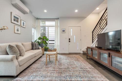a living room with a couch and a flat screen tv at Perch - Belmont Boutique 2 in Seattle