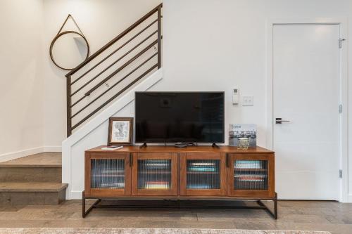 a flat screen tv sitting on top of a wooden entertainment center at Perch - Belmont Boutique 2 in Seattle