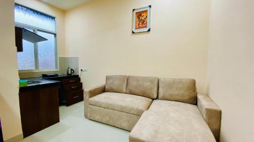 a living room with a couch and a television at Stay10 B&M LUXURY ACCOMDATION in Indore