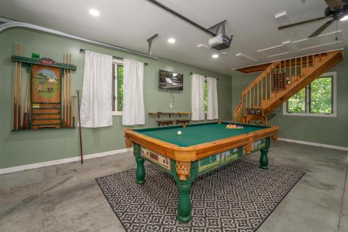 a room with a pool table and a staircase at Peace of Heaven in Connestee in Brevard