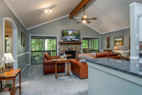 a living room with a couch and a fireplace at Peace of Heaven in Connestee in Brevard