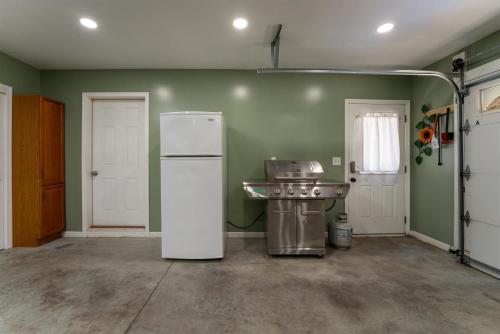 an empty kitchen with a refrigerator and a sink at Peace of Heaven in Connestee in Brevard