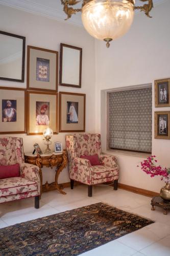 a living room with two chairs and a table at Srinivas The Royal Residence, Jaipur in Jaipur