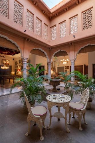 a courtyard with tables and chairs in a building at Srinivas The Royal Residence, Jaipur in Jaipur
