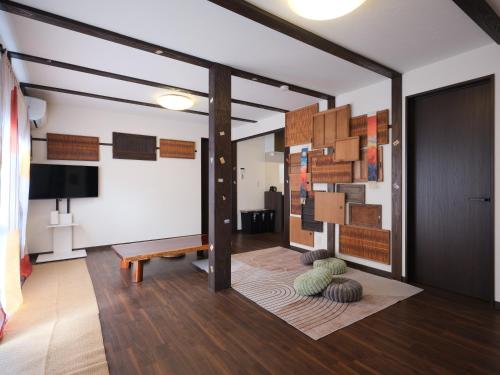 a living room with a table and a bench at mori HOUSE-vacation rental in Tokyo