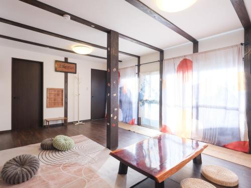 a living room with a wooden table and a table at mori HOUSE-vacation rental in Tokyo
