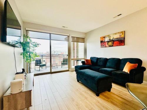 a living room with a couch and a large window at Scenic Downtown Loft with Pool in Indianapolis