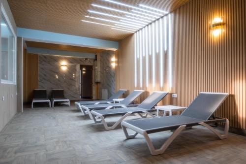 a row of chairs in a waiting room at Hotel Mio City in Kula