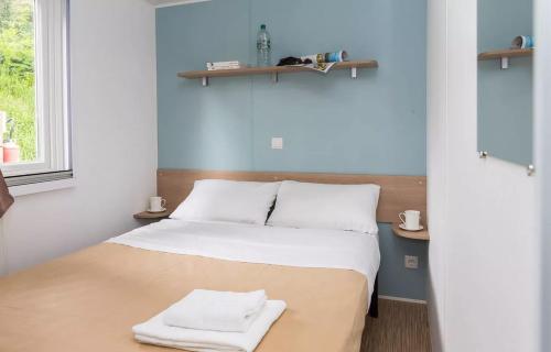 une chambre avec un lit avec deux serviettes dessus dans l'établissement Domaine Résidentiel de Plein Air Le Vorlen, à Fouesnant