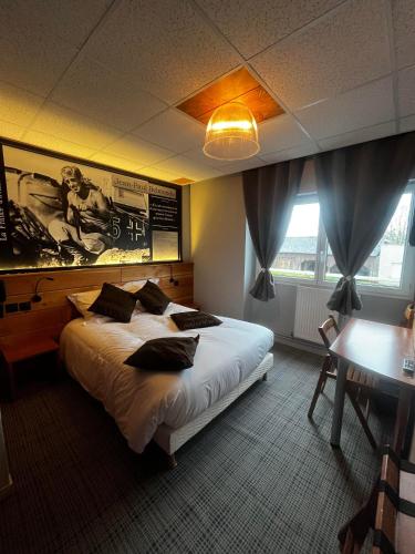 a bedroom with a large bed with pillows on it at au petit quinquin in Céaux