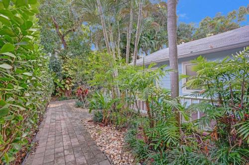 a brick walkway leading to a house with plants at Tropical Oasis Studio w Pool in Fort Lauderdale
